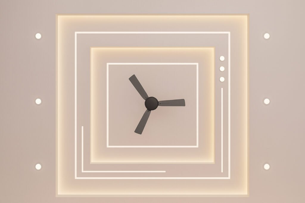 Minimalist false ceiling design with geometric square patterns, cove lighting, and a modern black ceiling fan