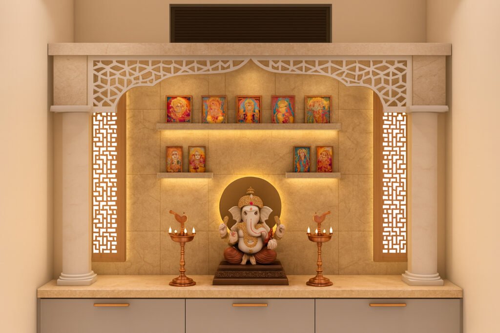 Elegant modern home mandir (prayer space) design featuring a beautifully carved white and beige marble backdrop with delicate lattice panels and cylinder pillars on each side. The center displays a decorative Lord Ganesha idol, highlighted by warm ambient backlighting, and is flanked by two traditional brass oil lamps. The shelves above hold framed images of various Hindu deities with soft, recessed lighting, creating a serene and spiritual ambiance perfect for worship.